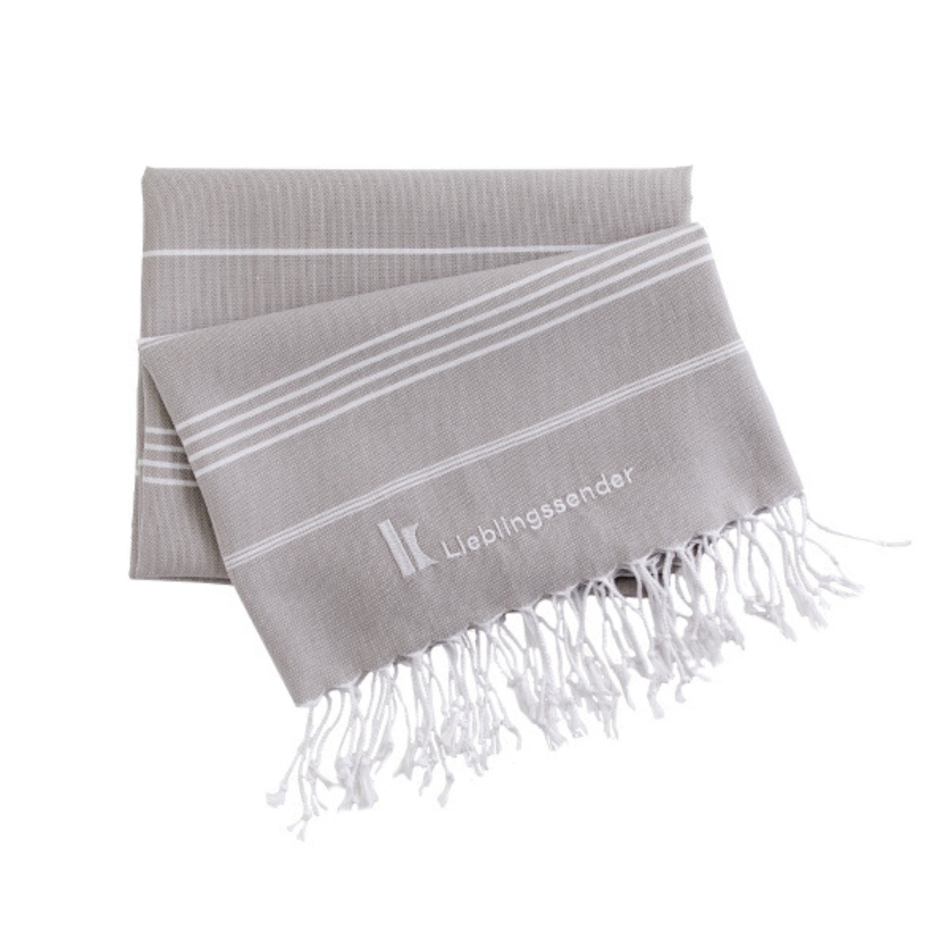 Klassik Radio Hamamtuch, zusammengefaltet mit K von Klassik Radio-Logo und dem Wort Lieblingssender eingestickt, hellgrau und weiß