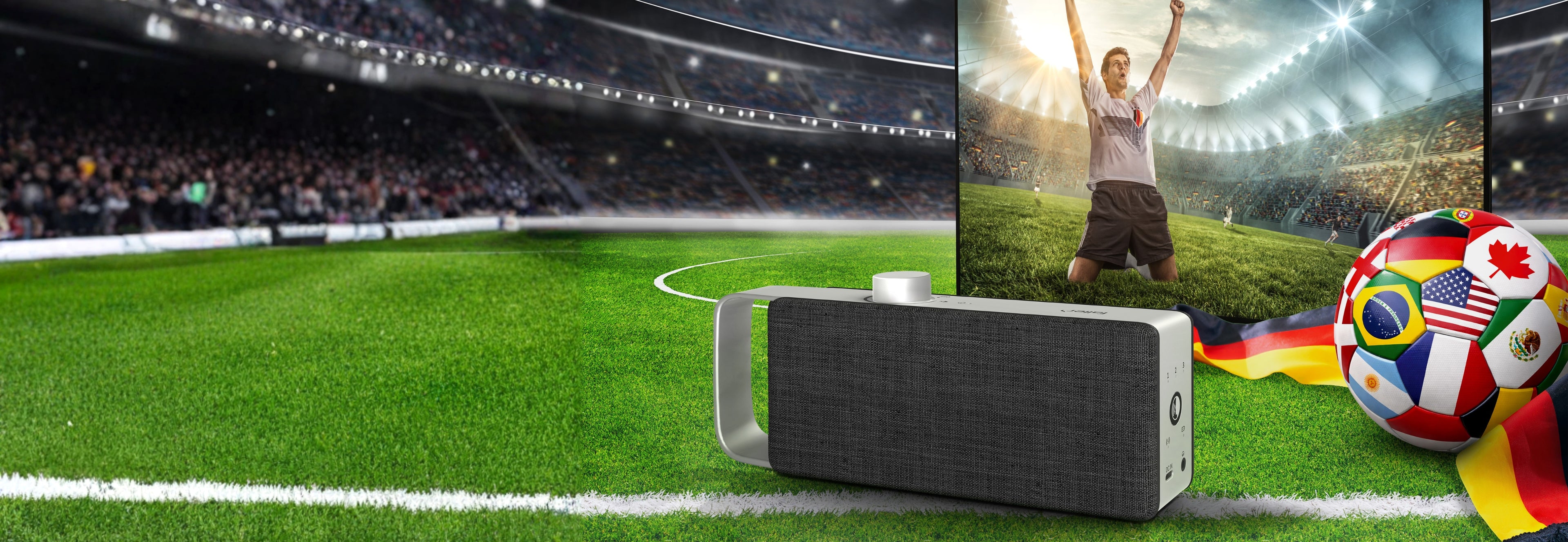 Fußballstation im Hinterrund, vorne ein Fernseher mit dem Bild eines jubelnden Fußballspielers und dem TV Sprachverstärker OSKAR, seitlich ein Ball mit den Flaggen der Nationen