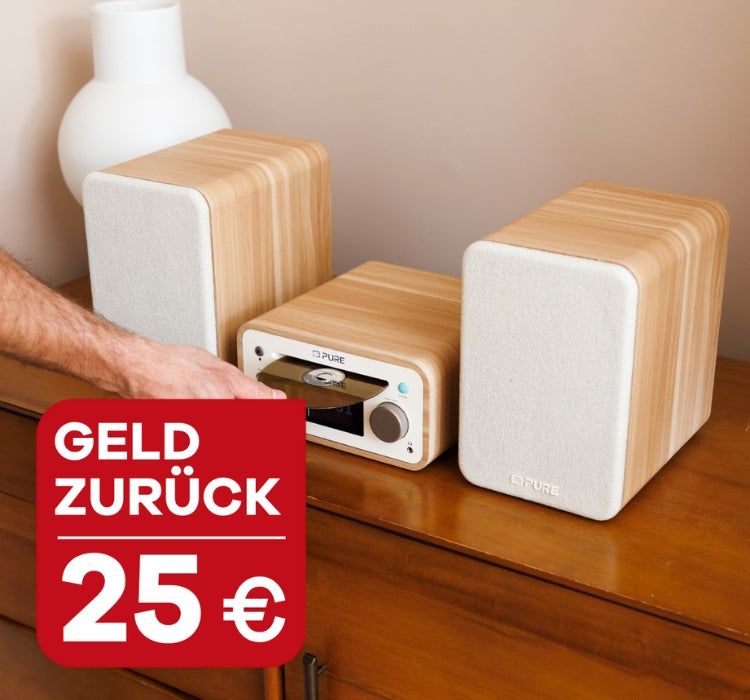 Pure Classic Sterei Mini Cotton White auf einem Holzschrank mit Hinweis auf 25 Euro Geld zurück